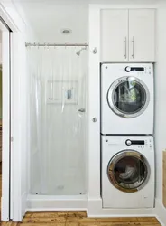 Washer and dryer in a column in the bathroom interior