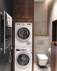 Washer and dryer in a column in the bathroom interior