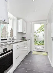 White kitchen with gray floor in the interior