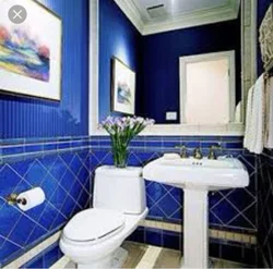 Photo of a bathtub with a blue floor