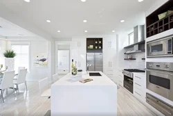 Modern living room interior with white kitchen