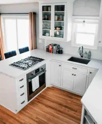 Gas stove by the window in the kitchen interior