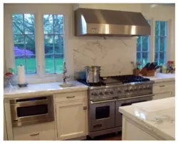 Gas stove by the window in the kitchen interior