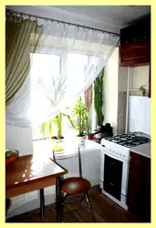 Gas stove by the window in the kitchen interior