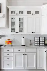 Kitchen with black handles in a white interior