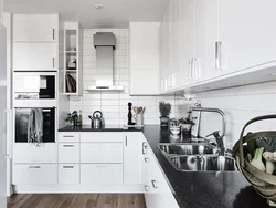 Kitchen with black handles in a white interior