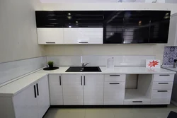 Kitchen with black handles in a white interior