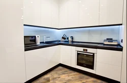 Kitchen with black handles in a white interior