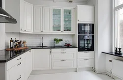 Kitchen with black handles in a white interior