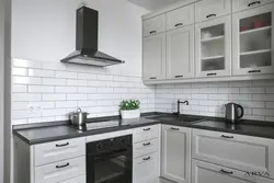 Kitchen With Black Handles In A White Interior