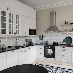 Kitchen with black handles in a white interior