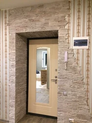 Decorating doors with decorative stone in an apartment photo
