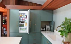 Free-standing refrigerator in the interior of the kitchen living room