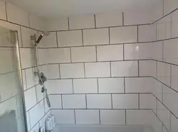 Grout for gray tiles in the bathroom photo