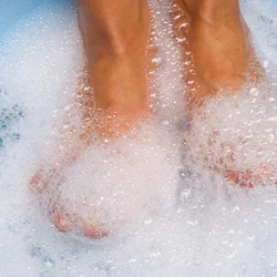 Photo of a bathtub with foam and legs