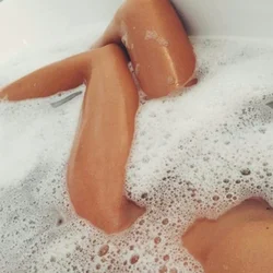 Photo of a bathtub with foam and legs