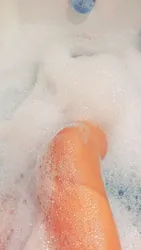 Photo of a bathtub with foam and legs