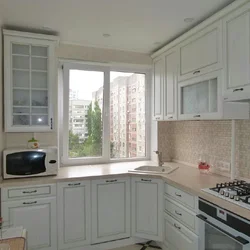 Photo of a kitchen on one wall with a window