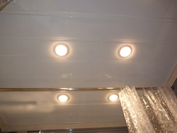 Bathroom ceiling made of plastic panels with spotlights photo