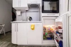 Small kitchen with refrigerator and table photo