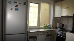 Small kitchen with refrigerator and table photo