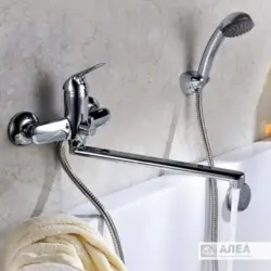 Photo of a faucet in a bathroom with a shower