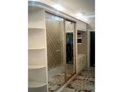 Sliding Wardrobes In The Hallway With A Mirror And Shoe Rack Design