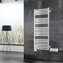 Electric heated towel rail in the bathroom interior photo