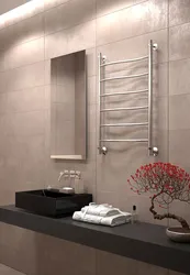 Electric heated towel rail in the bathroom interior photo