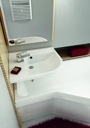 Bathtub with sink above it for a small bathroom photo