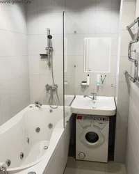 Bathtub with sink above it for a small bathroom photo