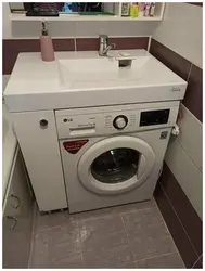 Photo Of A Washing Machine Under The Sink In The Bathroom