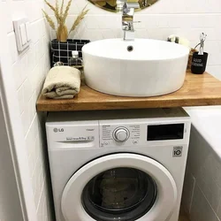 Photo Of A Washing Machine Under The Sink In The Bathroom