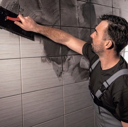 Grouting tiles in the bathroom photo