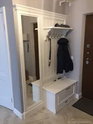 Hallways in the corridor with a mirror and a shoe rack and a wardrobe photo