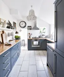 Gray kitchen with wooden countertop in the interior of the kitchen living room