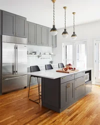 Gray kitchen with wooden countertop in the interior of the kitchen living room