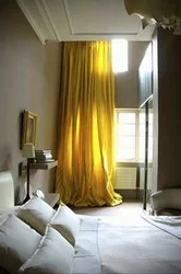 Yellow curtains in the bedroom interior photo