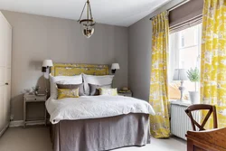 Yellow curtains in the bedroom interior photo