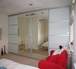 Wall-to-wall wardrobe in the bedroom photo with a view