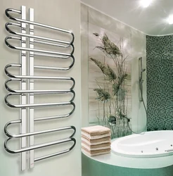 White heated towel rail in the bathroom interior