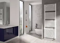 White heated towel rail in the bathroom interior