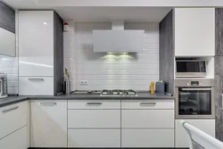 White kitchen design with black appliances