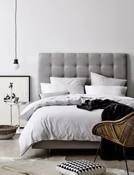 Gray soft bed in the bedroom interior