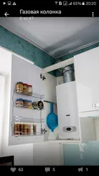 Kitchen design with a gas boiler on the wall and pipes photo