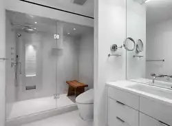 Photo of a bathroom with a toilet and a shower corner