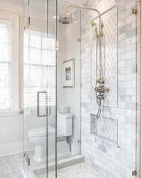 Photo of a bathroom with a toilet and a shower corner