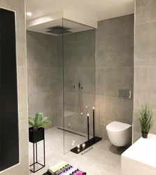 Photo of a bathroom with a toilet and a shower corner