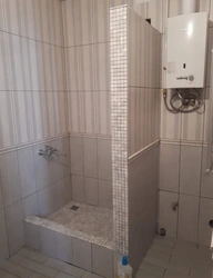 Photo of a tiled shower in a small bathroom