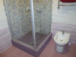 Photo of a tiled shower in a small bathroom
